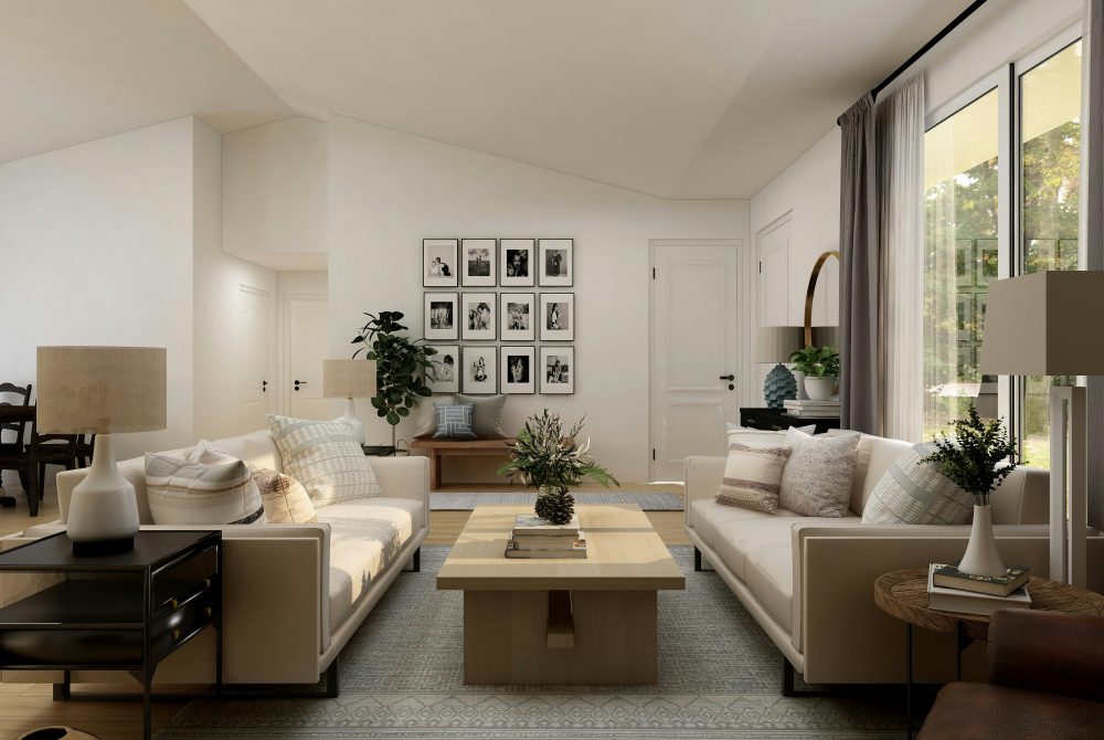 Inviting living room design with plenty of natural light, plants, and sentimental photographs on the wall, which all contribute to a more positive feeing and better mental health